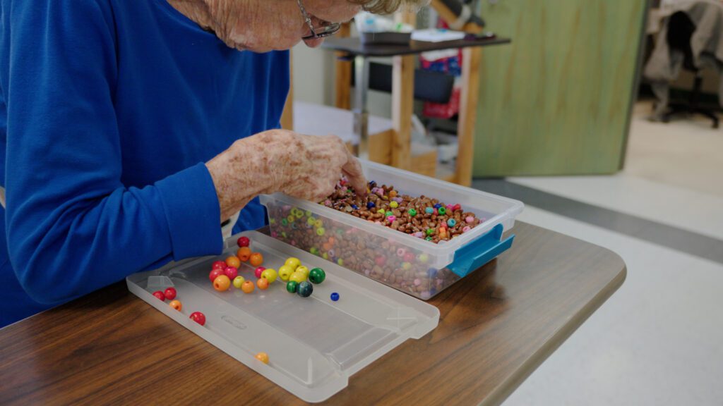A woman does memory care therapy at a skilled nursing facility