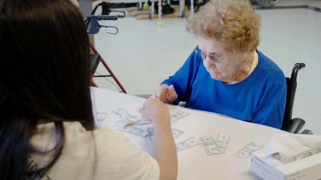 A woman does memory care therapy at a skilled nursing facility